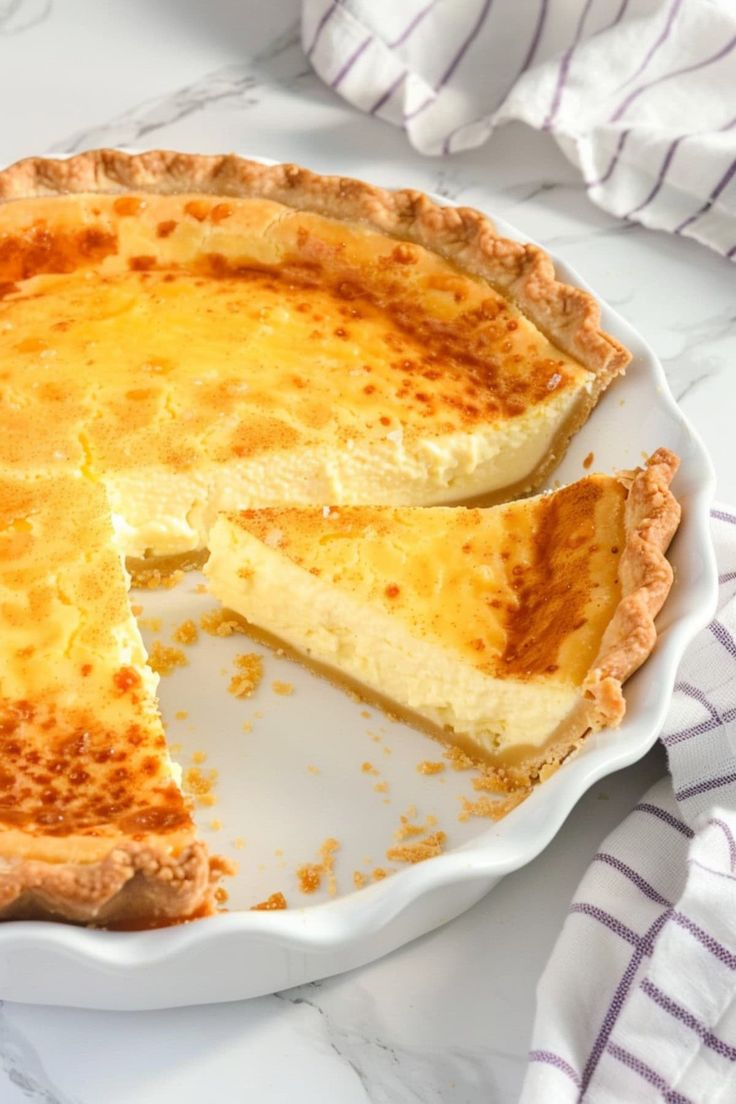 a cheese pie on a plate with one slice missing