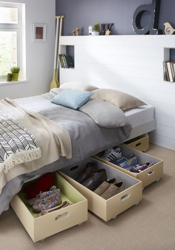 a bed with drawers underneath it in a bedroom