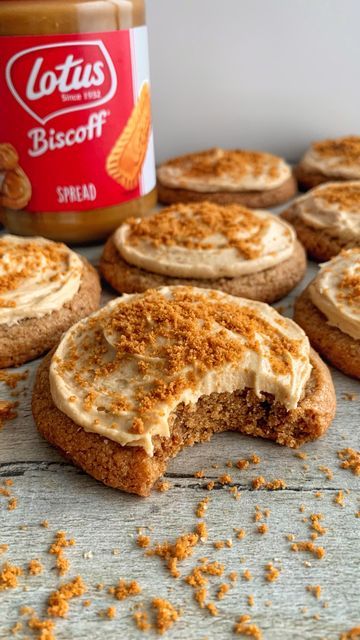 some cookies with frosting on them and a jar of peanut butter in the background