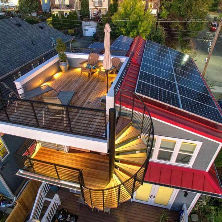 an aerial view of a house with solar panels on it's roof and deck