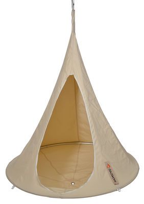 a white hanging chair with a beige cover on it