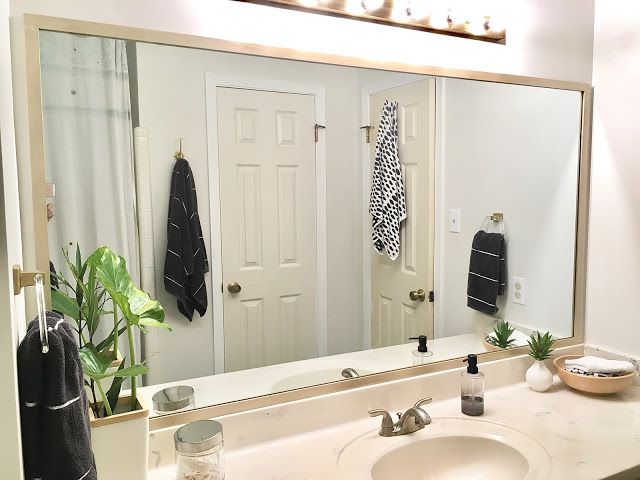 a bathroom with a large mirror and sink