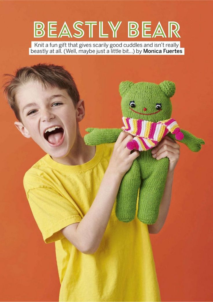 a young boy holding a green teddy bear in front of an orange background with the caption beastly bear