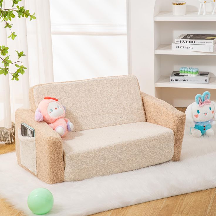 two stuffed animals sitting on a couch in a living room