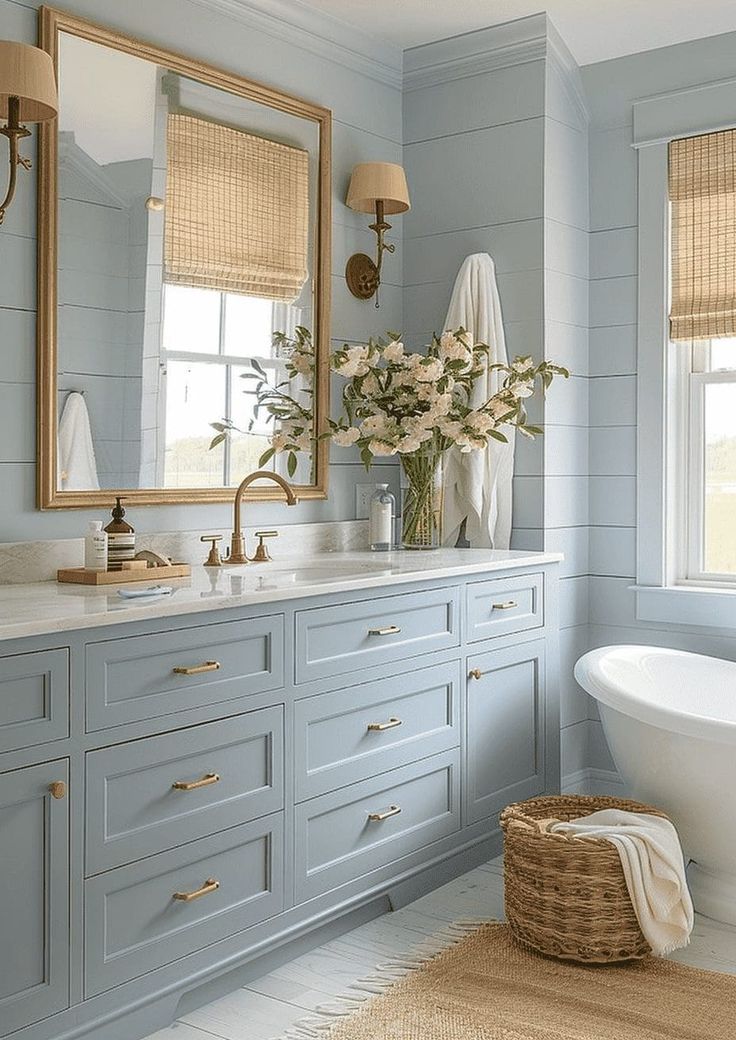 a bathroom with blue walls and white fixtures, including a claw foot bathtub in the center