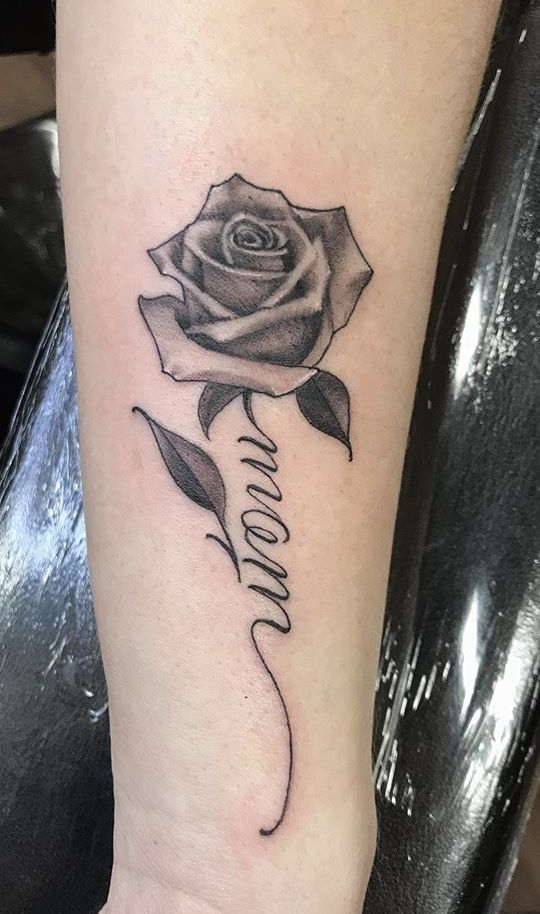 a black and white rose with the word mom written on it's side arm