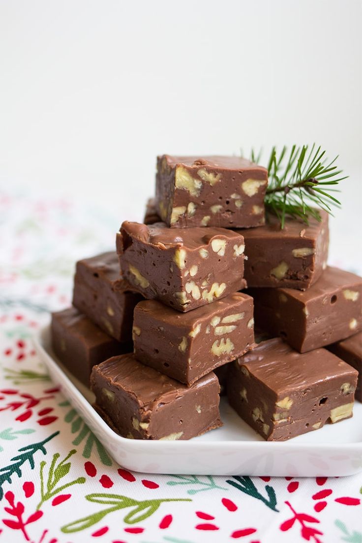 chocolate fudge bars stacked on top of each other with pine sprigs in the middle