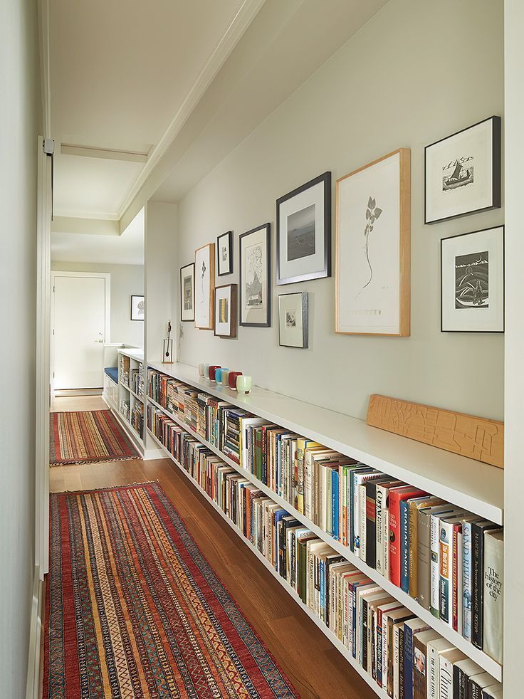 a long bookshelf filled with lots of books