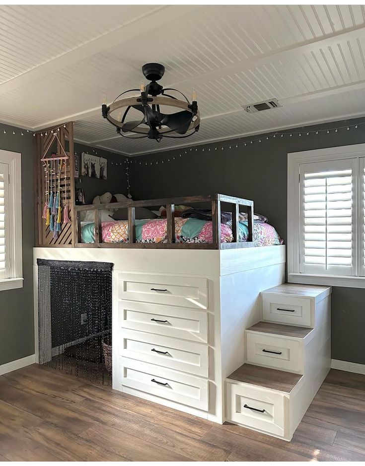 a loft bed with stairs leading up to the top and bottom bunk in a bedroom