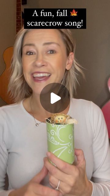 a woman holding a green cup filled with food and text that reads, a fun fall scarecrow song