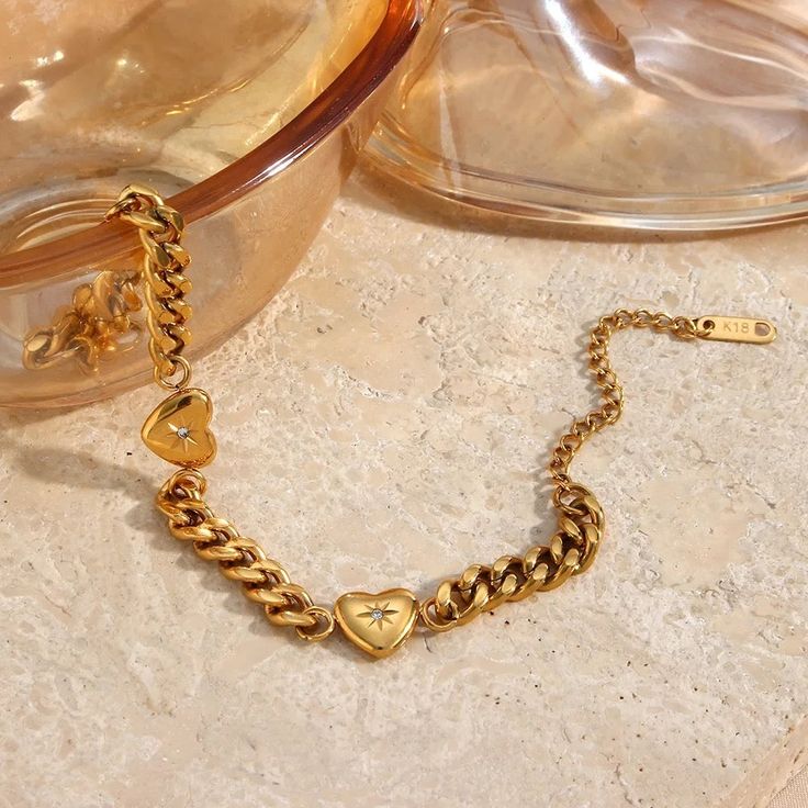 Classic never goes out of style and this one has hearts with a north star design giving you ultra feminine vibes. The Sammi Cuban Bracelet is definitely a must have in your jewelry collection. It can be worn alone or layered with our other gold bracelets. Dress it up or down either way its a stunner.*Shop the Sammi Necklace for a matching set! Gold: 18k gold platingMaterial: Stainless steelLength: 17cmWidth: 5mmWeight: 16g Waterproof jewelry Glazd Pouch with every order Free US shipping Easy Exc Gold Cuban Link Chain, Ocean Heart, Beaded Necklace Diy, Gold Bracelet For Women, Chain Bracelets, Gold Heart Necklace, Jewellery Uk, Waterproof Jewelry, Jewelry Design Necklace