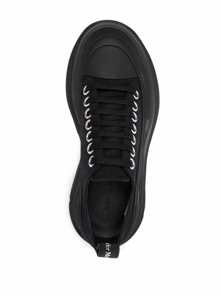 Black Tread Slick canvas sneakers from Alexander McQueen featuring round toe, contrasting toecap, front lace-up fastening, branded insole, pull-tab at the heel and platform sole. | Alexander McQueen Tread Slick canvas sneakers Alexander Mcqueen Tread Slick, Canvas Sneakers, Sneakers Black, All Black Sneakers, Lace Front, Alexander Mcqueen, Black Color, Alexander, Lace Up