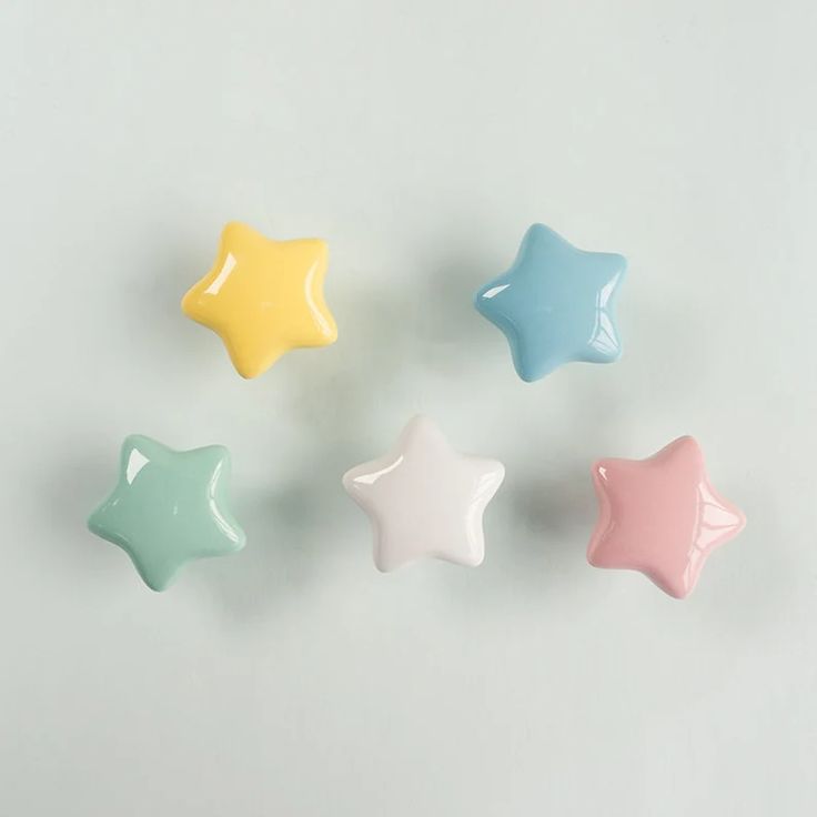 four star shaped ceramic dishes in pastel colors