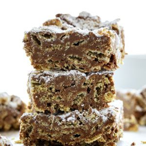 a stack of brownies sitting on top of a white plate