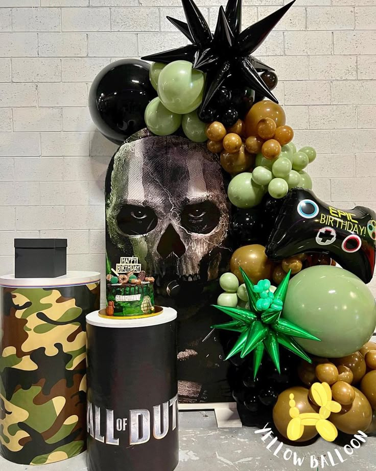 a table topped with balloons and decorations next to a cup filled with coffee beans on top of a counter