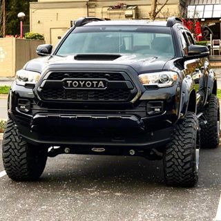 a black toyota truck parked in a parking lot