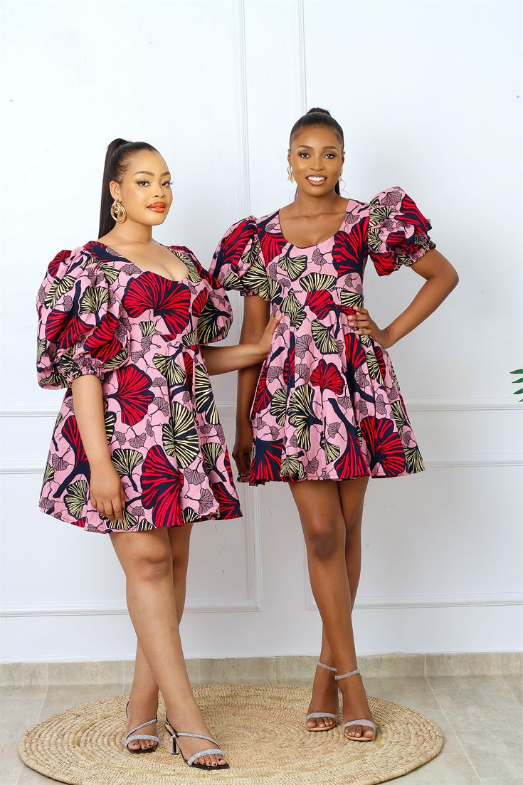 Beautiful African print Ankara skater dress. Flamboyant bubble sleeves with an elastic cuff. Fit and flare cut. Beautiful bold colors bring out the most feminine silhouettes. This outfit is the complete Contemporary African look perfect for all occasions. Made with High quality 100% African Wax cotton Fully lined Features pockets on both sides Made in Nigeria Models are 5’10 and 5’9 wearing a US6/UK10 and US12/UK16 Dress Length 36" CARE INSTRUCTIONS: Hand wash cold, DO NOT BLEACH, Hang dry, Pres Ankara Skater Dress, African Print Dress, Waxed Cotton, Dress Pink, Skater Dress, African Print, Bold Colors, Fit And Flare, Pink Dress