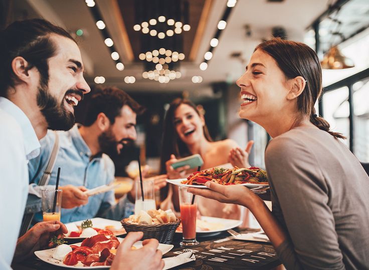 group of people sitting at table eating food and smiling stock photo id9768