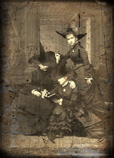 an old photo of three people dressed as witches