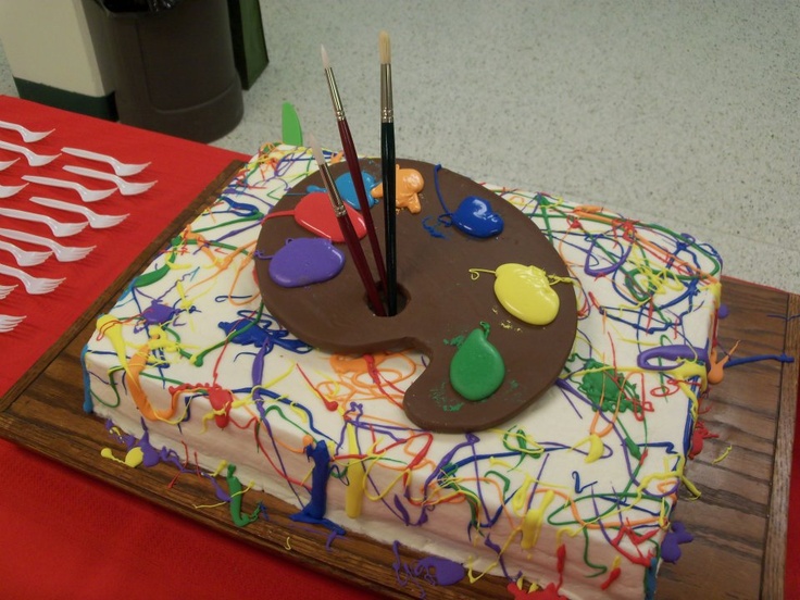 a birthday cake with paint and brushes on it