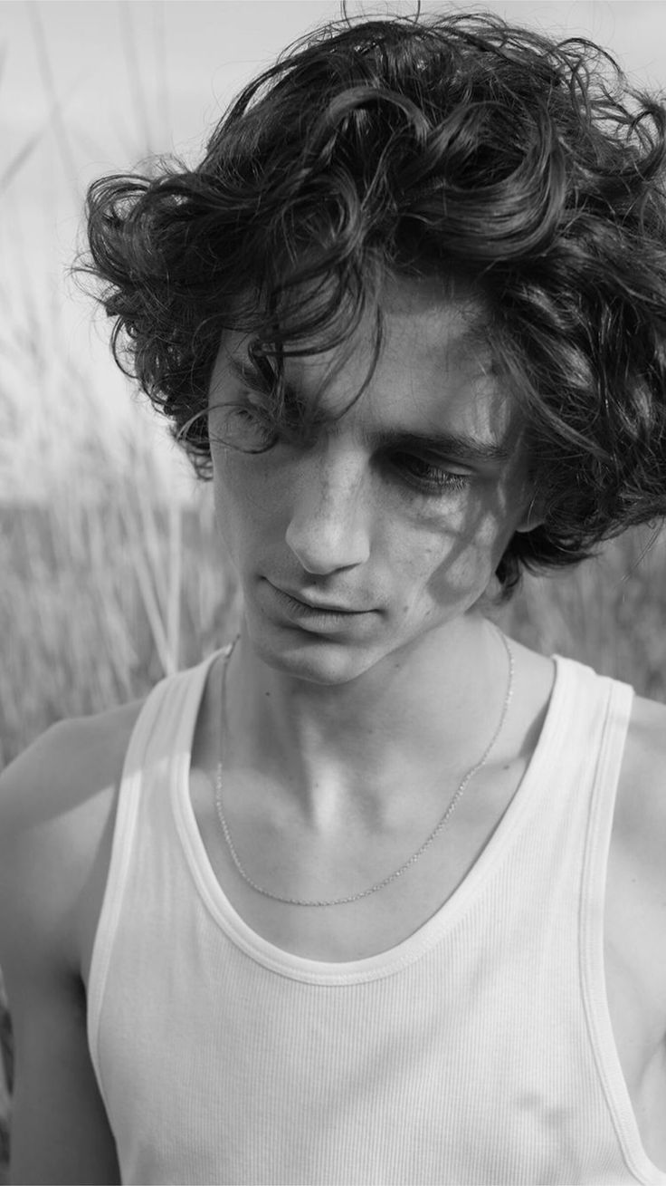 black and white photograph of a man with curly hair