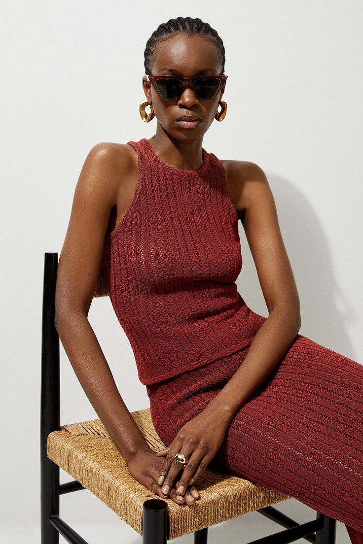 a woman in a red dress sitting on a chair