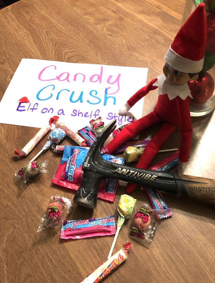 an elf is sitting on the table with candy and toothbrushes in front of him