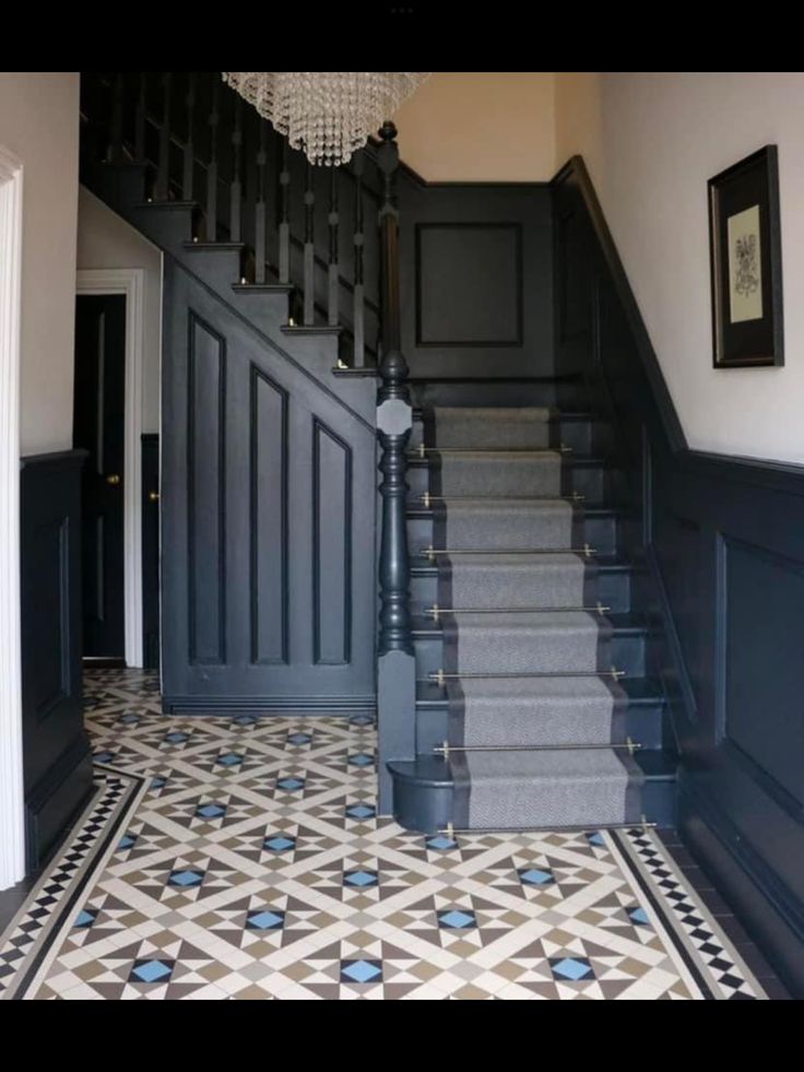 the stairs in this house are painted black and white with blue trimmings on them