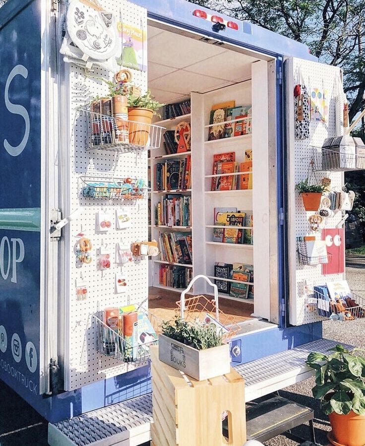 a blue and white truck with shelves full of books