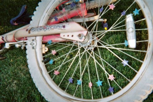 a close up of a bicycle tire with stars on the spokes and an electronic device attached to it