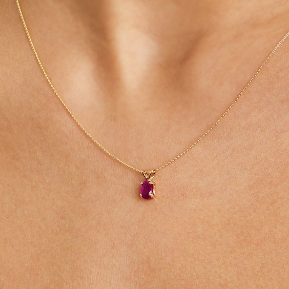 14K Yellow Gold Oval Ruby Birthstone Necklace. The birthstone of July, rubies symbolize royalty, power and passion, and are said to bring vitality, courage, romance and friendship to those who wear them. This brilliant ruby pendant is the perfect piece for your special someone. aka Gemstone Necklaces Spiritual Oval Ruby Jewelry, Ruby Birthstone Oval Pendant Necklace, Ruby Round Pendant Birthstone Necklace, Oval Ruby Birthstone Necklace, Oval Ruby Necklace With Birthstone, Cabin Door, Ruby Birthstone, Gemstone Necklaces, Jewelry Accessories Ideas