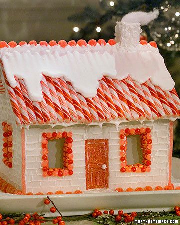 a gingerbread house with candy canes on the roof