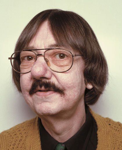 an older man with glasses and a mustache