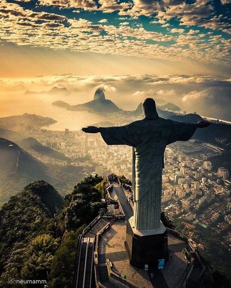 the statue of christ stands on top of a mountain