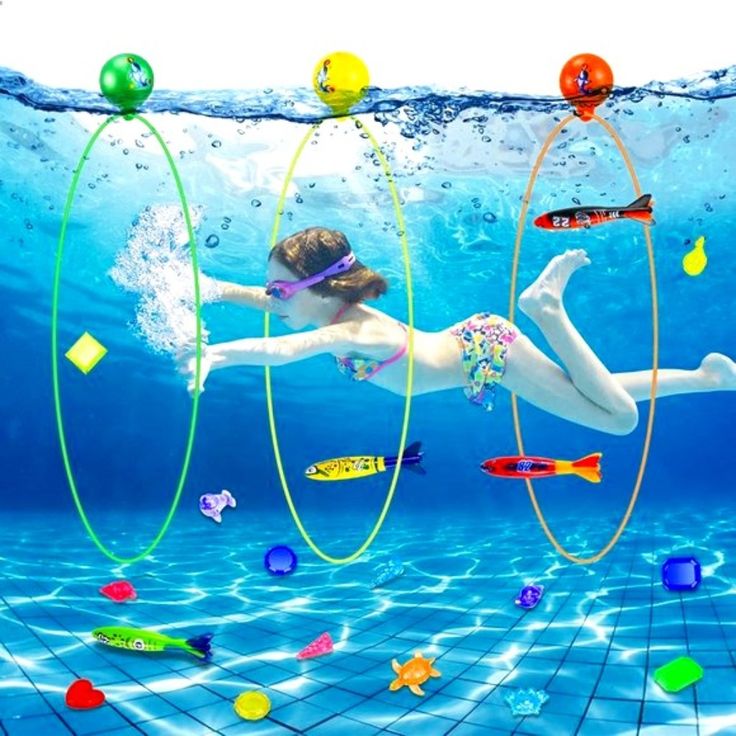 a woman swimming in the water surrounded by colorful objects