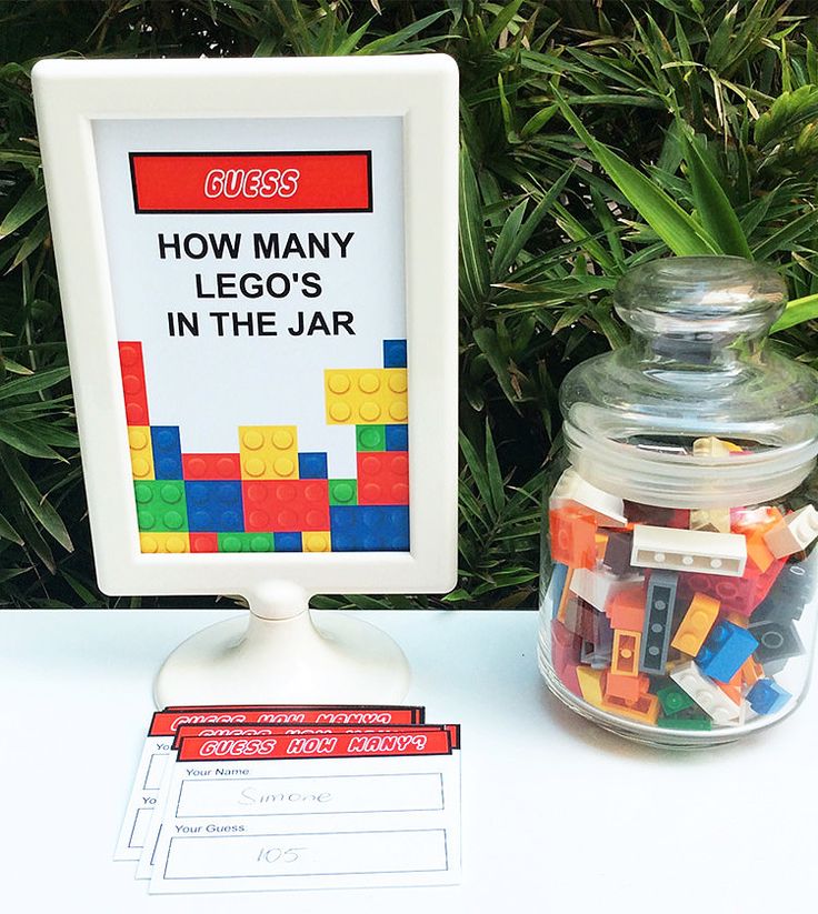 there is a jar with legos in it next to a sign that says how many lego's in the jar