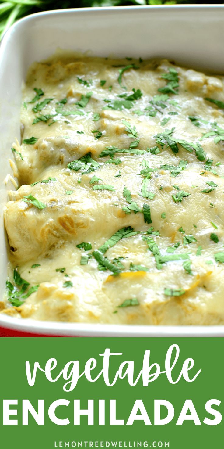 vegetable enchiladas in a red casserole dish with green garnish