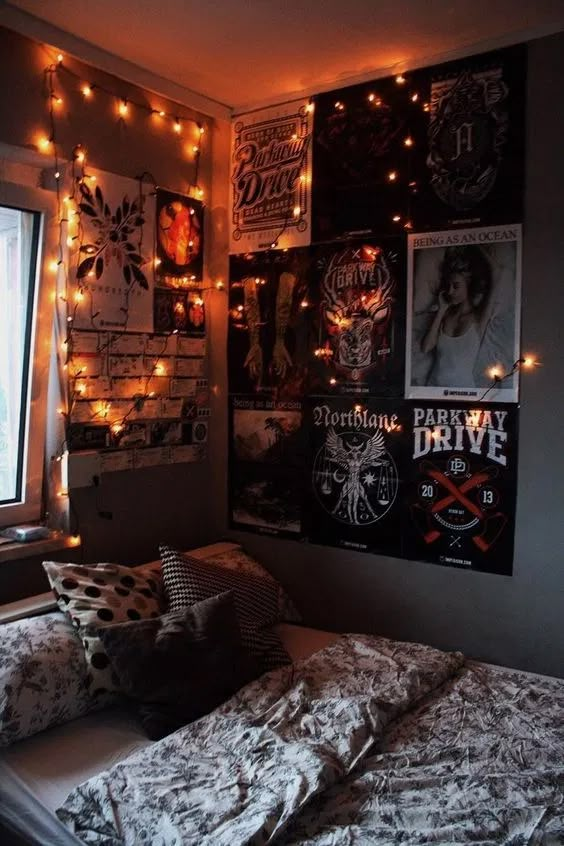 a bedroom with posters and lights on the wall