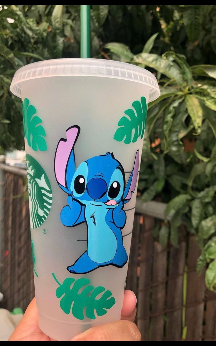 someone is holding up a plastic cup with an image of stitching on it