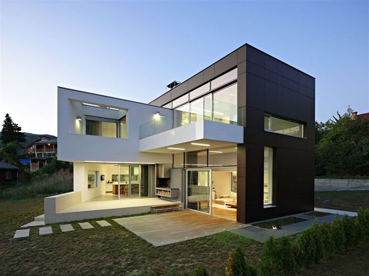 a modern house with large windows on the outside