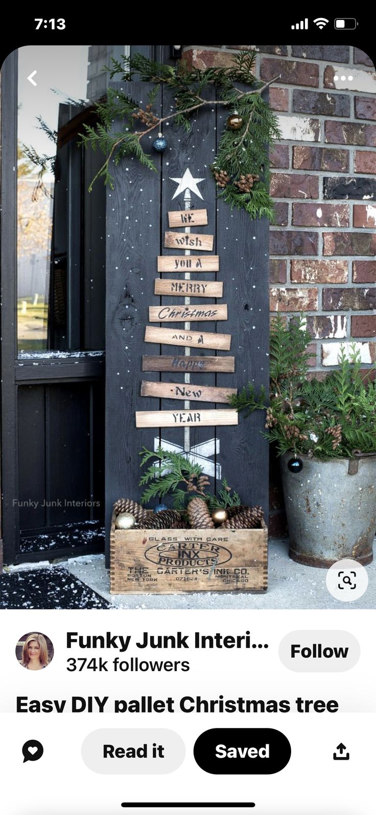 a christmas tree made out of wooden planks on the front door of a house