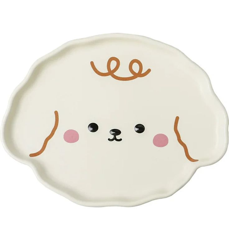 a white plate with an animal face painted on it