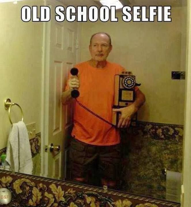 an old man holding a trophy in front of a bathroom mirror with the caption, old school selfie