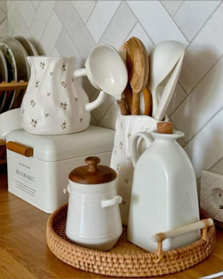 white dishes and utensils are sitting on the counter