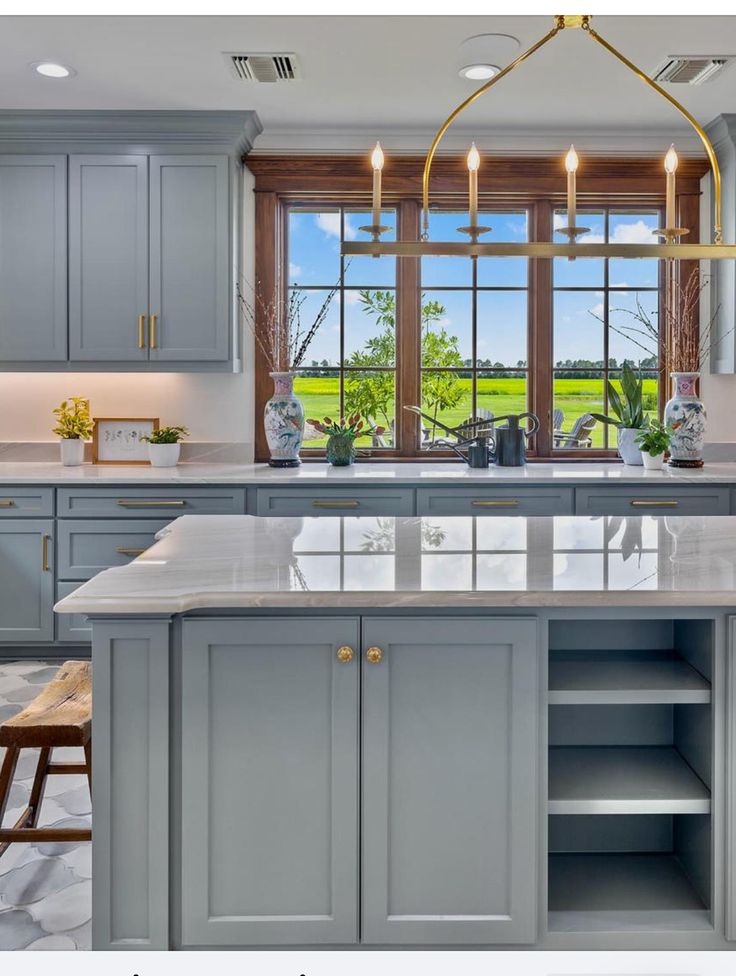 a large kitchen with gray cabinets and marble counter tops is featured in the magazine's march / june issue