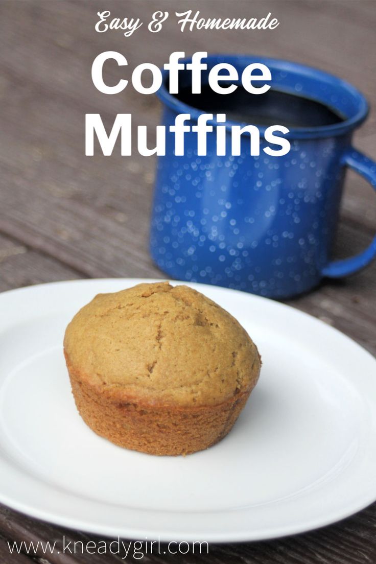 a muffin sitting on top of a white plate next to a blue coffee mug