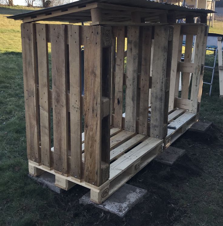 a wooden structure sitting in the grass