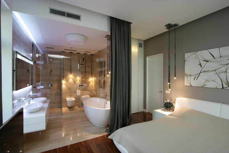 a large white bed sitting in a bedroom next to a bath tub