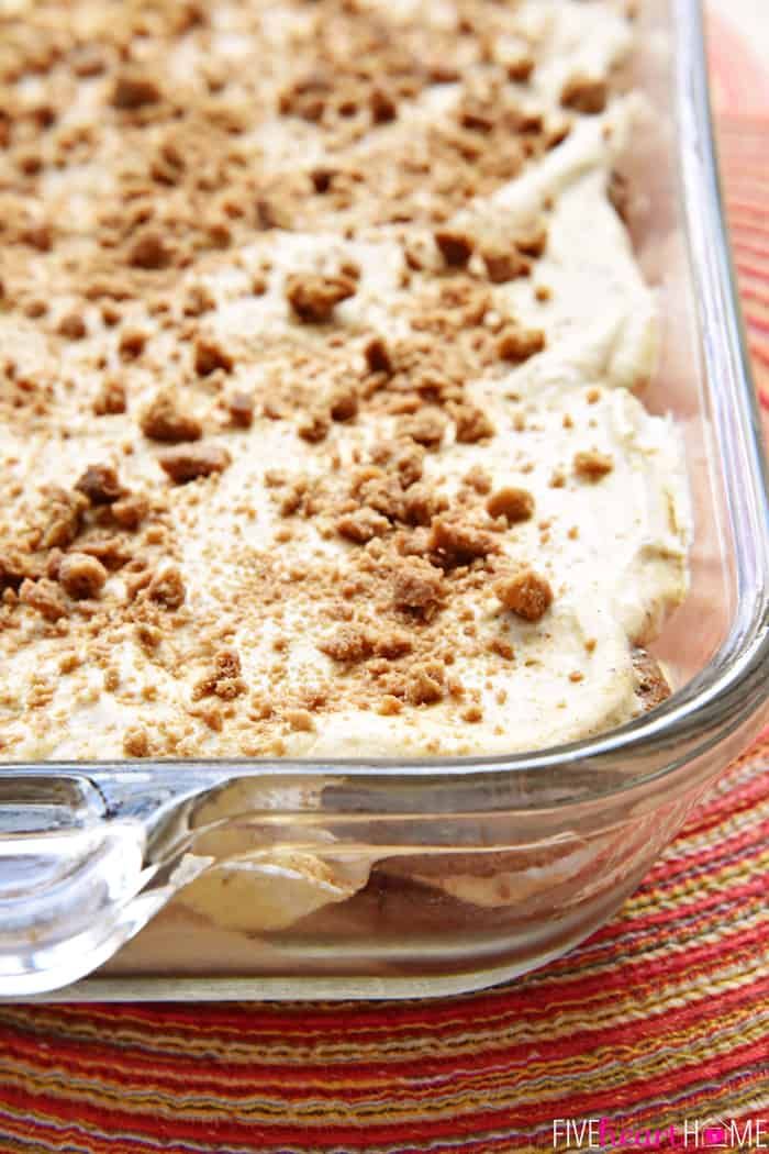 a casserole dish filled with food on top of a red and white table cloth