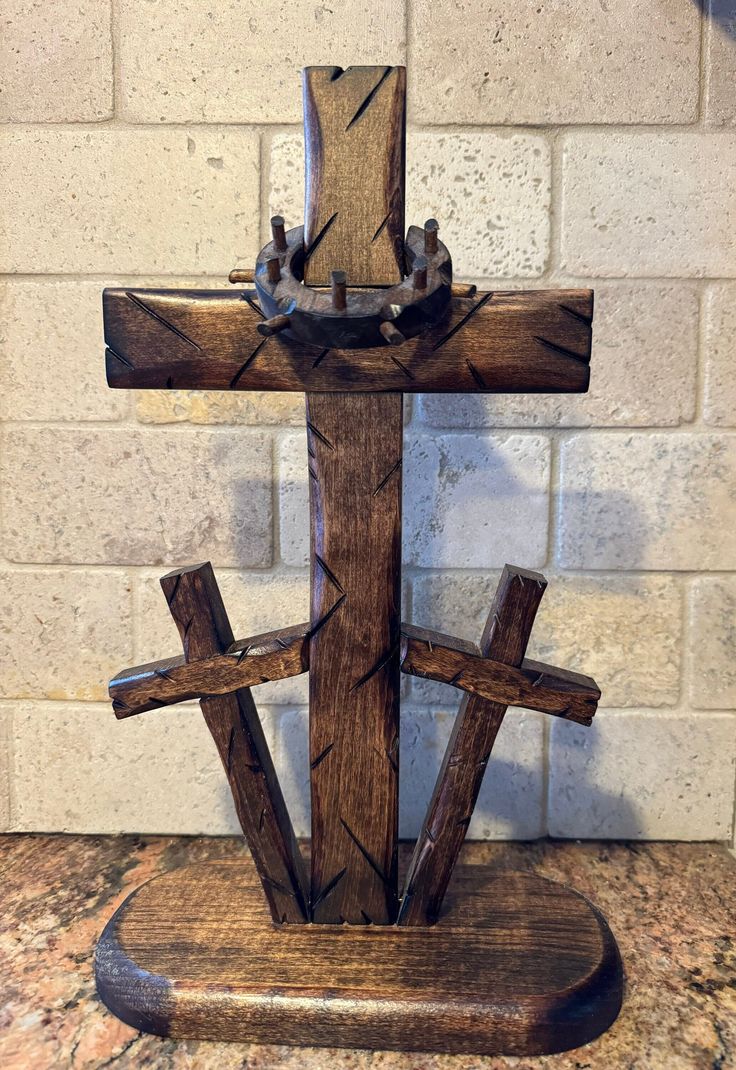 a wooden cross sitting on top of a counter